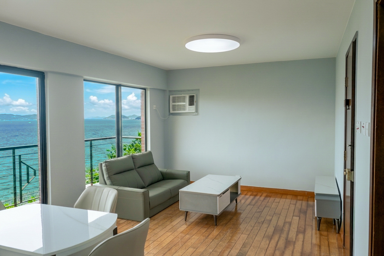 Living room with floor-to-ceiling windows opening onto the South China Sea